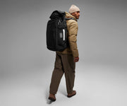 6'2" person wearing the 55L Boot Bag and winter clothes
