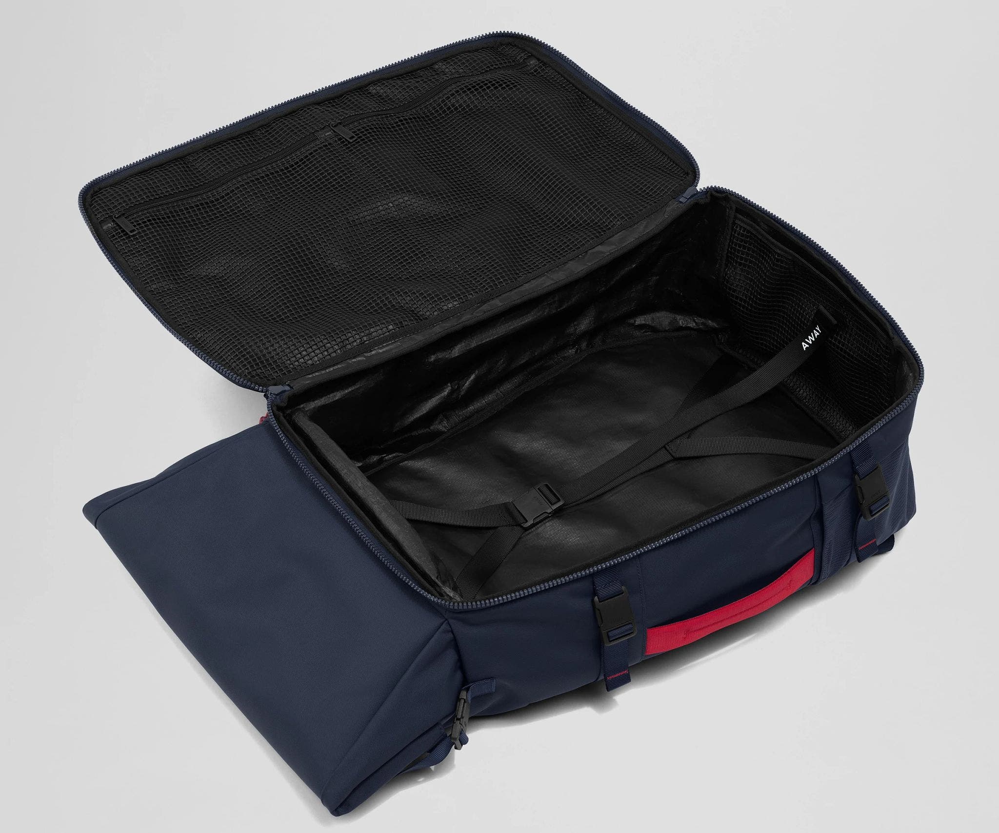 Open, unpacked Carry-On Boot Bag 55L showing the mesh zipper pockets and compression straps
