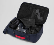 Ski boots packed into the removable boot cube inside the Boot Bag. Winter hat and clothing in the front mesh pockets