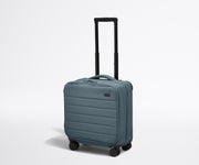 Angled product view of The Softside Compact Carry-On suitcase in Coast Blue with raised handle