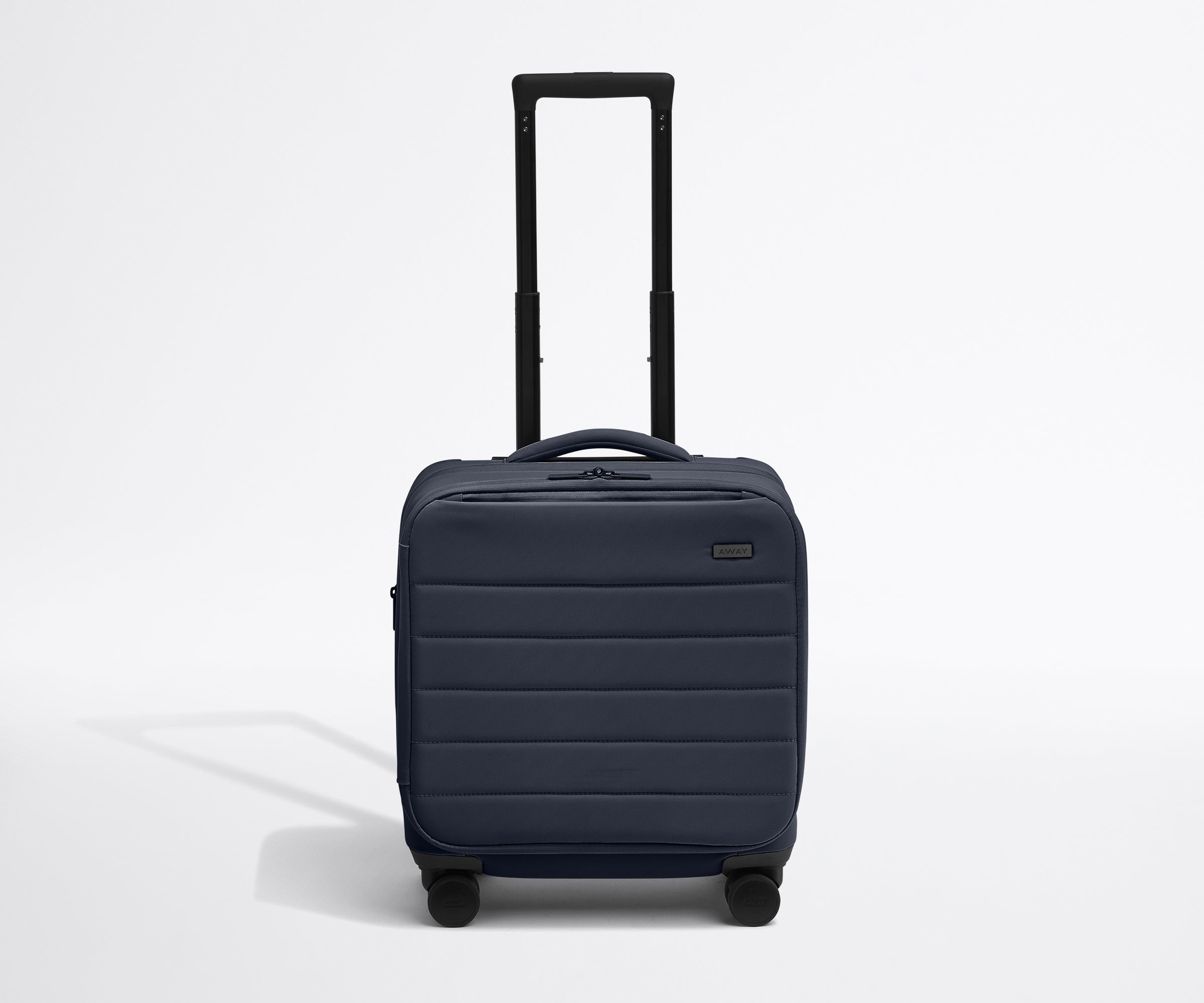 Front product view of The Softside Compact Carry-On suitcase in Navy Blue with raised handle