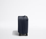 Side product view of The Softside Compast Carry-On suitcase in Navy Blue shown fully expanded
