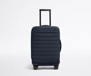 Front product view of The Softside Carry-On suitcase in Navy Blue with raised handle