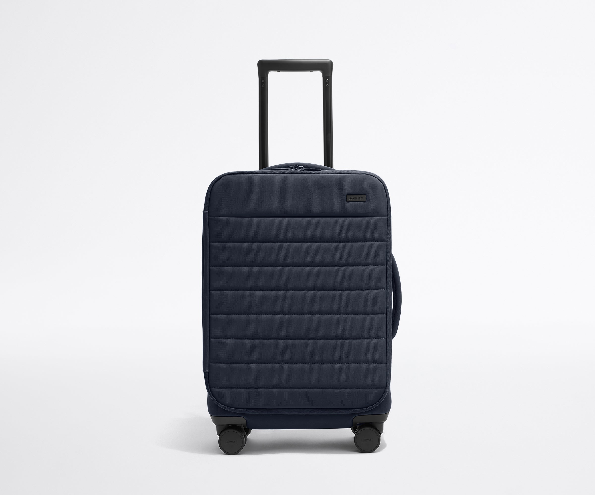 Front product view of The Softside Carry-On suitcase in Navy Blue with raised handle