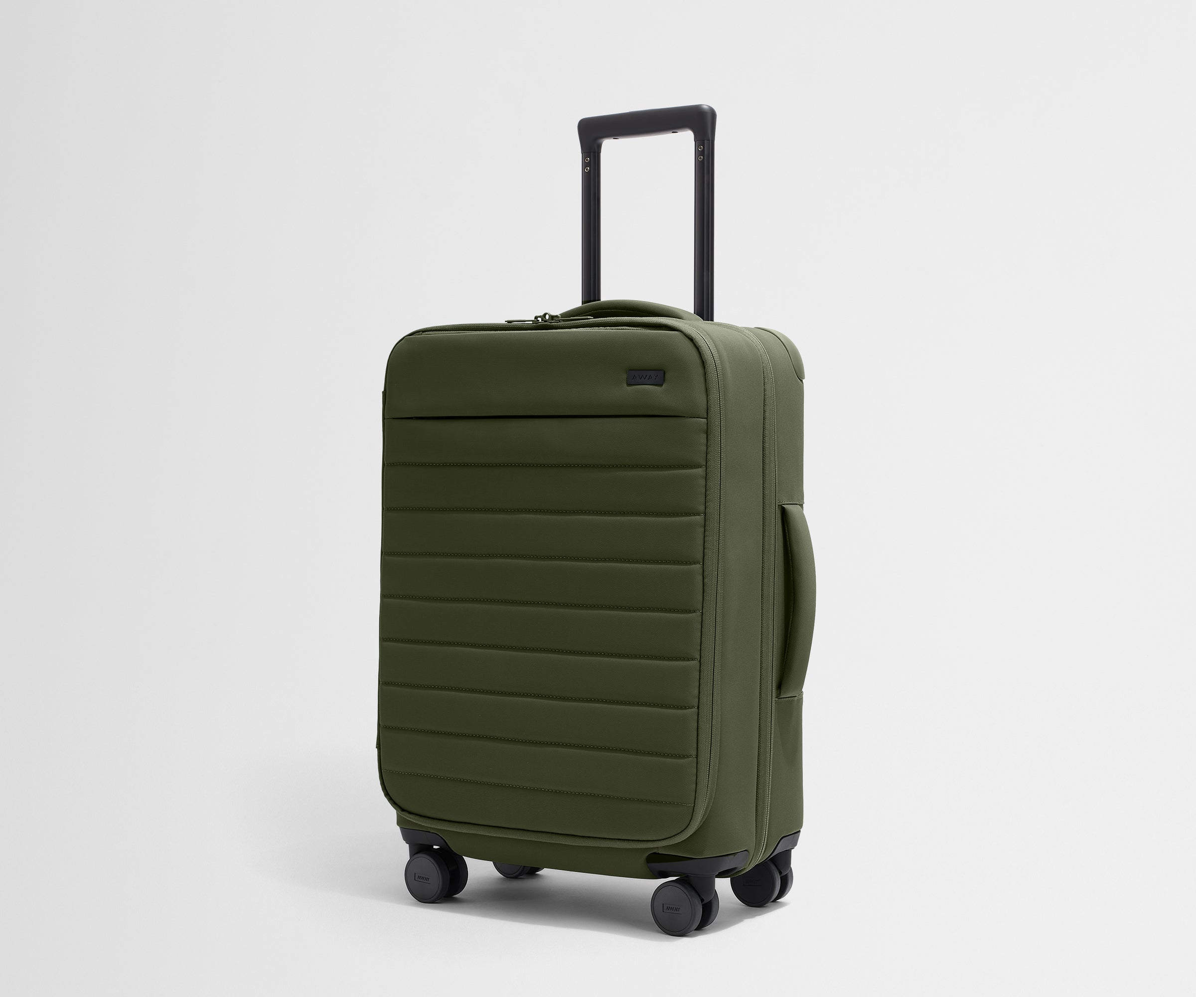 Angled product view of The Softside Bigger Carry-On suitcase in Olive Green with raised handle