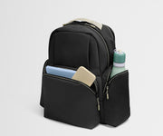 Black backpack with compartments containing a phone, tablet, and water bottle on a light gray background