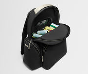 Black backpack with open compartment showing rolled-up items on a light gray background