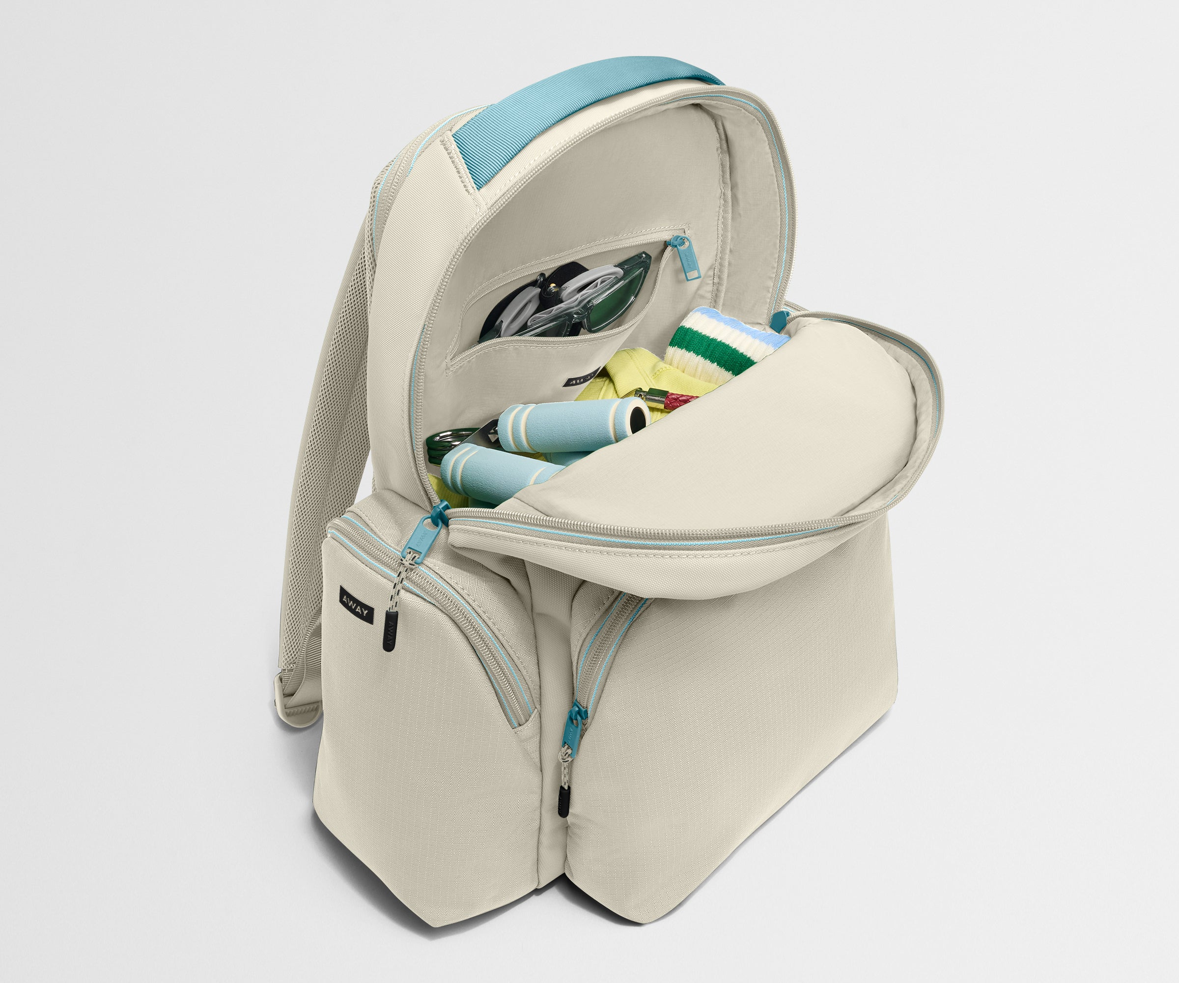 Beige backpack with a blue strap on a white background