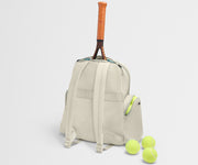 Beige backpack with a tennis racket and balls on a light gray background