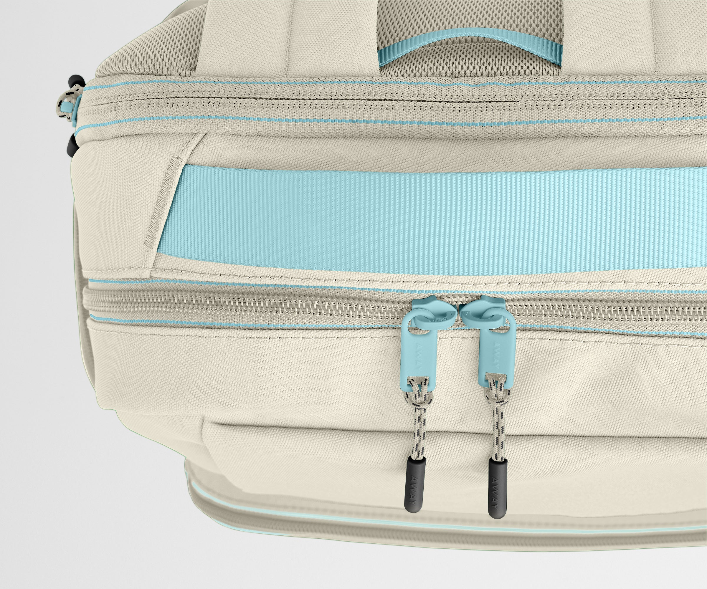 Close-up of a beige backpack with blue zippers on a light gray background
