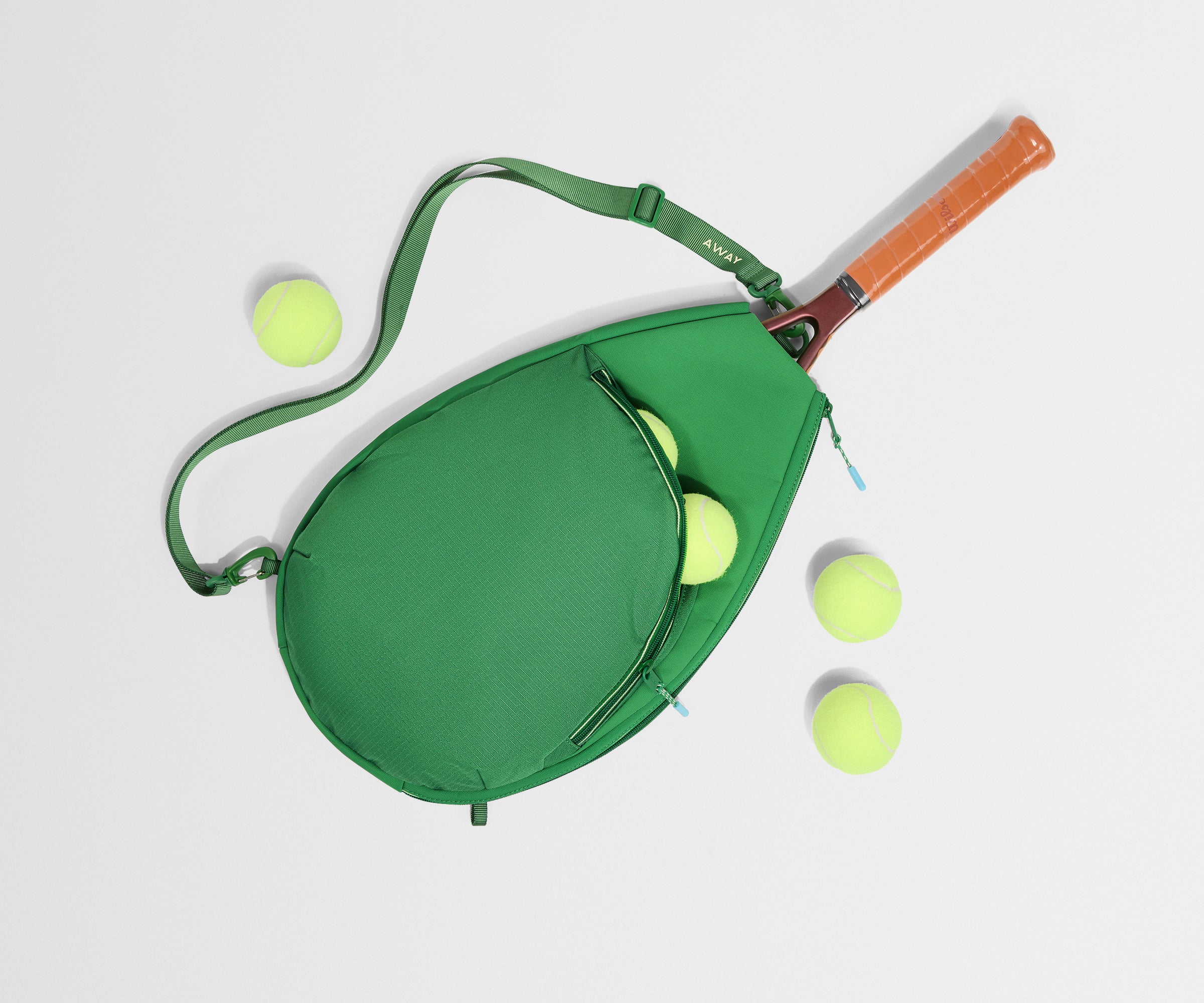 Green tennis racket case with a tennis racket and balls on a light gray background