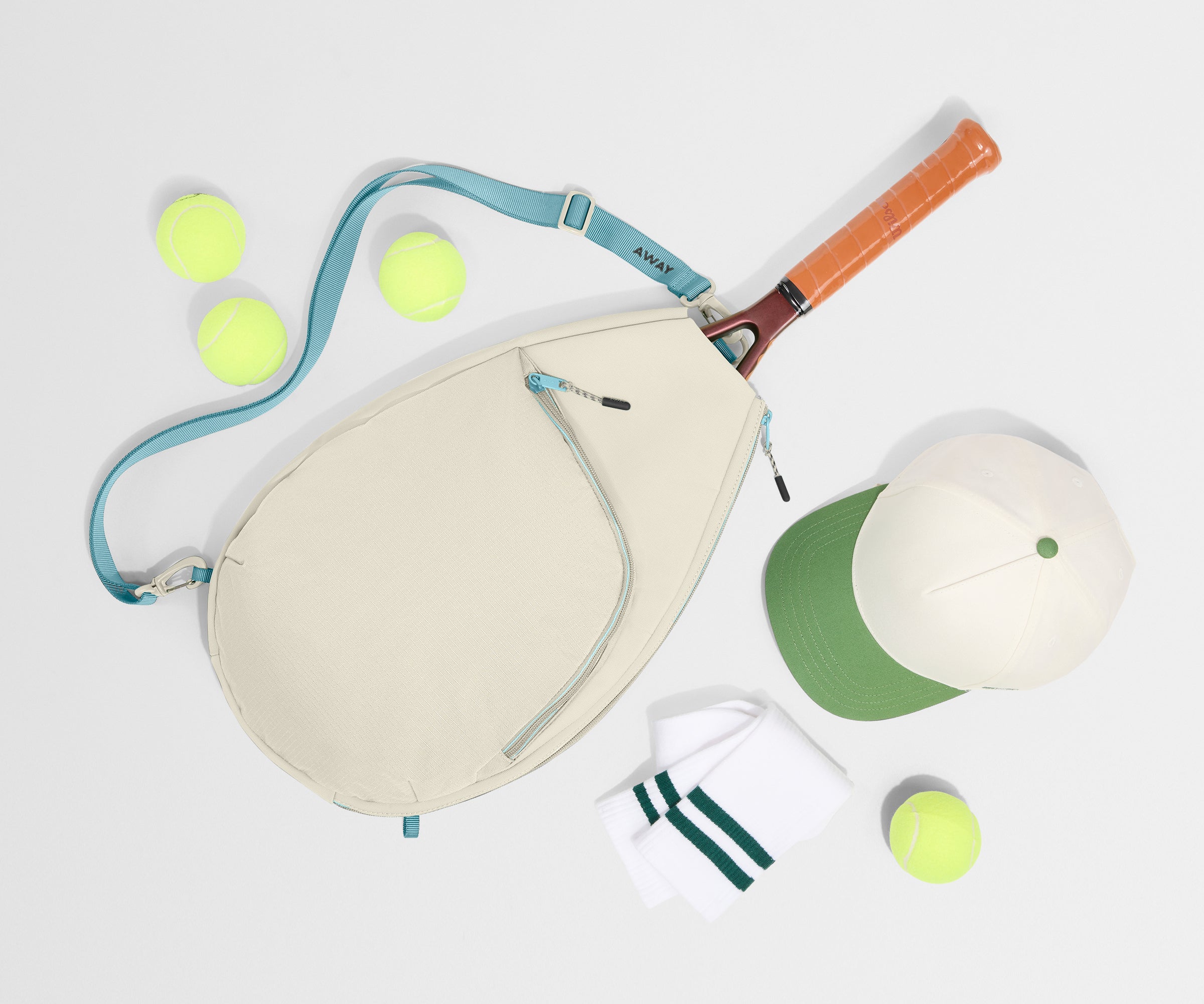 Paddle, paddle cover, and tennis balls on a white background