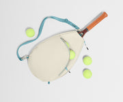 Paddle and tennis balls on a light gray background