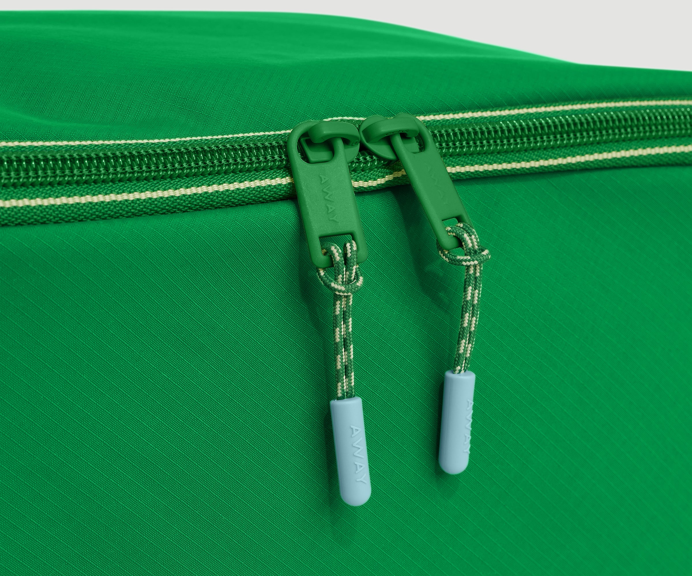 Close-up of a green zipper on a green shoe cube