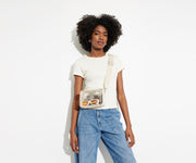 The clear Stadium Bag worn crossbody on female talent, letting her be hands free, and showing how clear the bag so it meets stadium and venue regulations