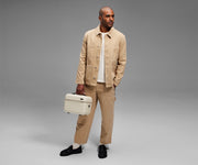 Person carrying the Train Case by its top handle