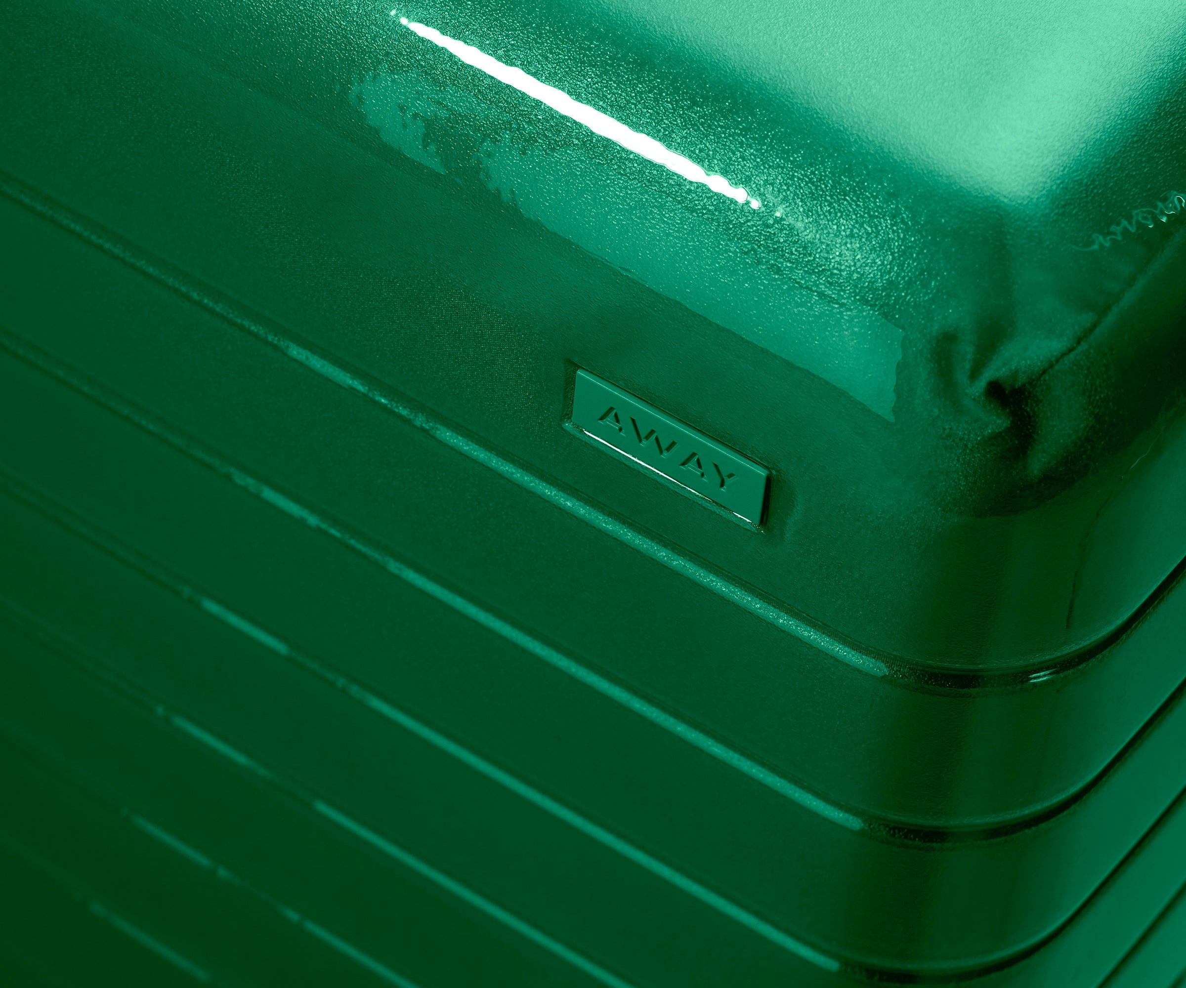 Zoomed in product view of The Carry-On suitcase in Translucent Green to show the semi-transparent shell and opaque, color-matched interior lining