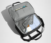 Main interior packed with clothing. Slip pockets packed with a notebook and charging cords