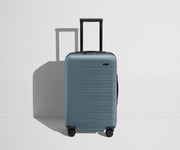 Front product view of The Carry-On Flex suitcase in Coast Blue with raised handle