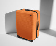 Angled product view of The Large suitcase in Sorbet Orange