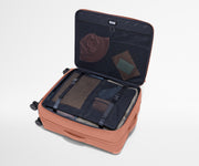 Open Softside suitcase, with travel essentials in the front flap pocket and compression pad pockets