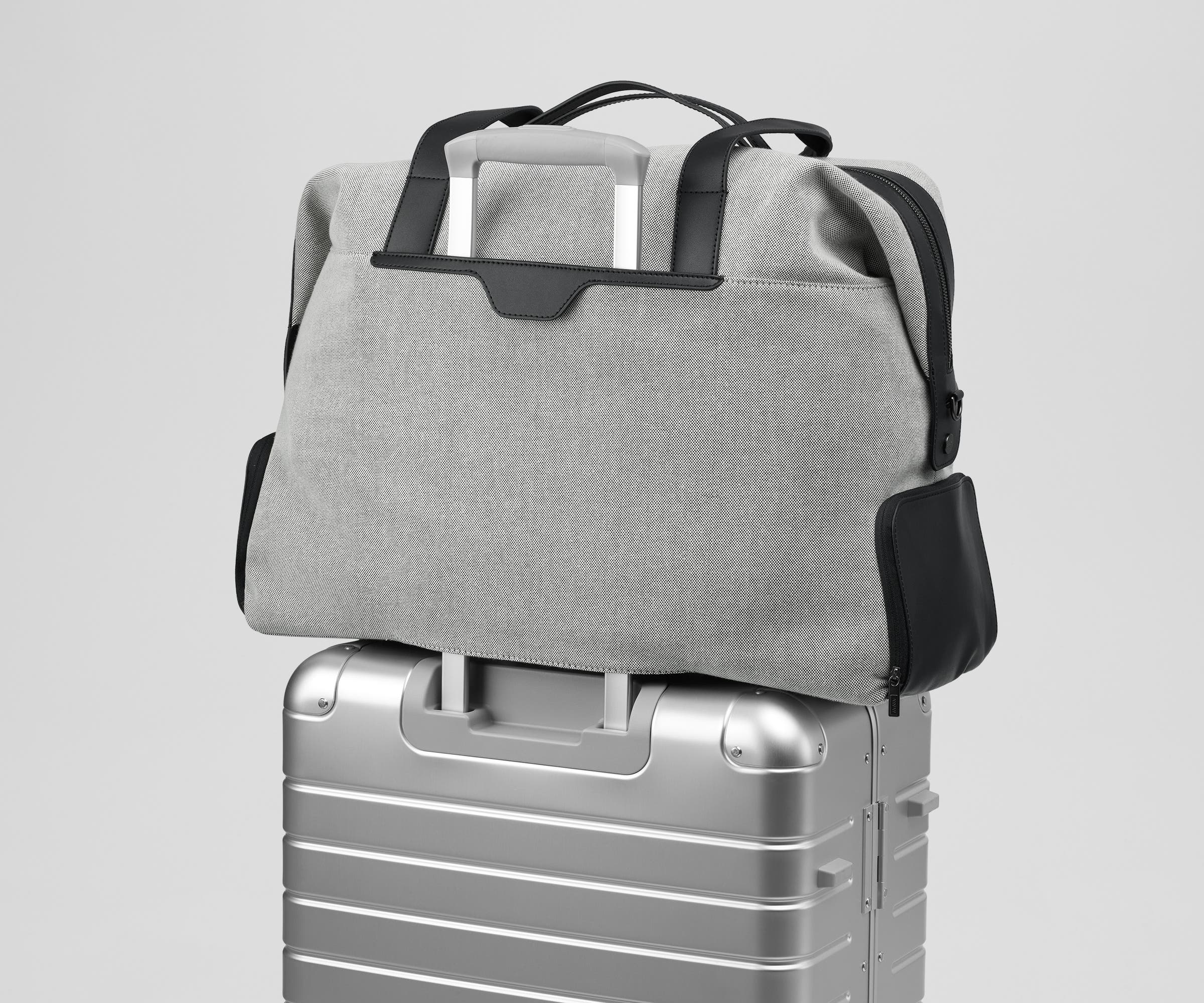 Transit Canvas Weekender on top of an Aluminum Away suitcase