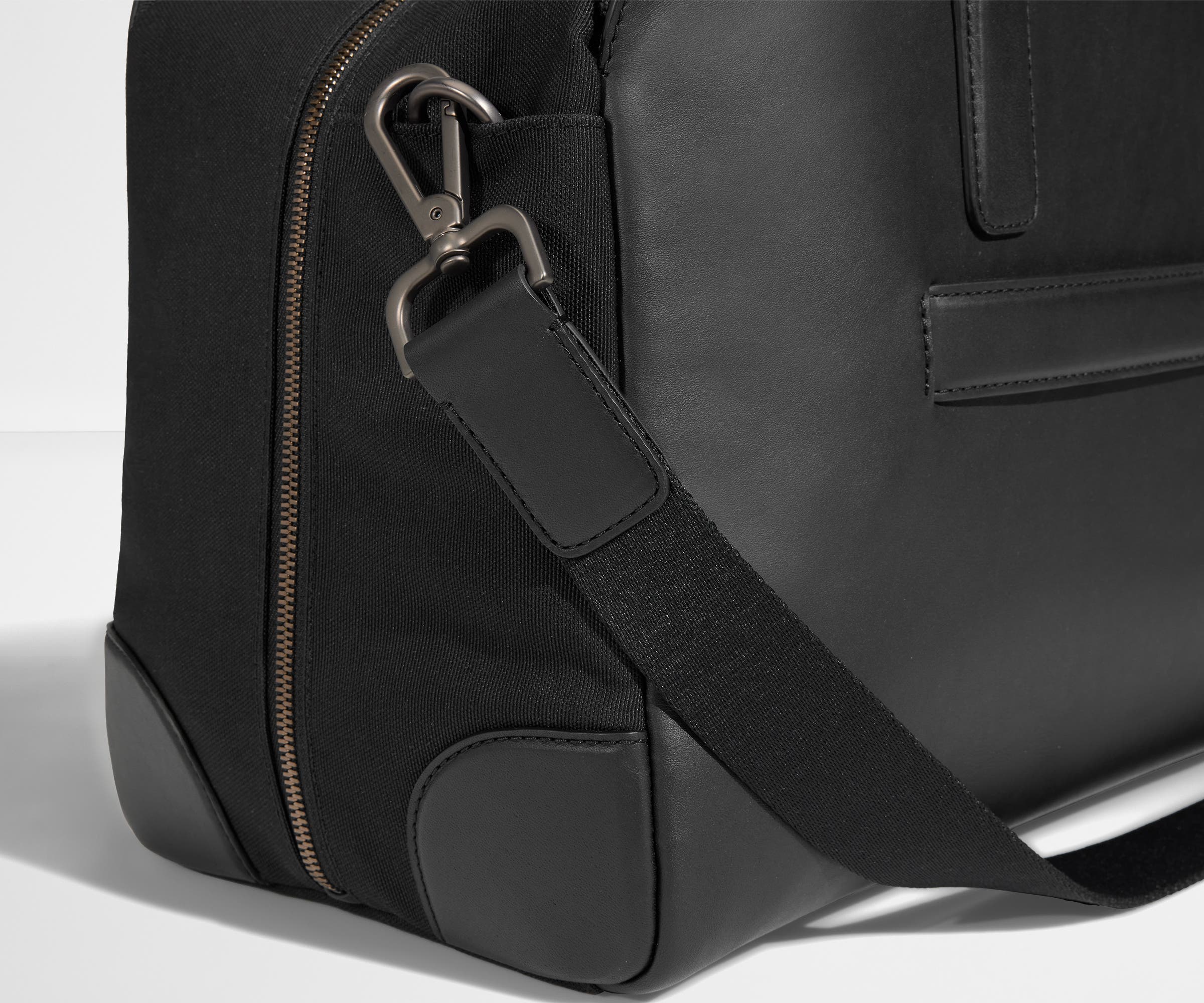 Detailed view of the canvas and leather material, including the removable shoulder strap