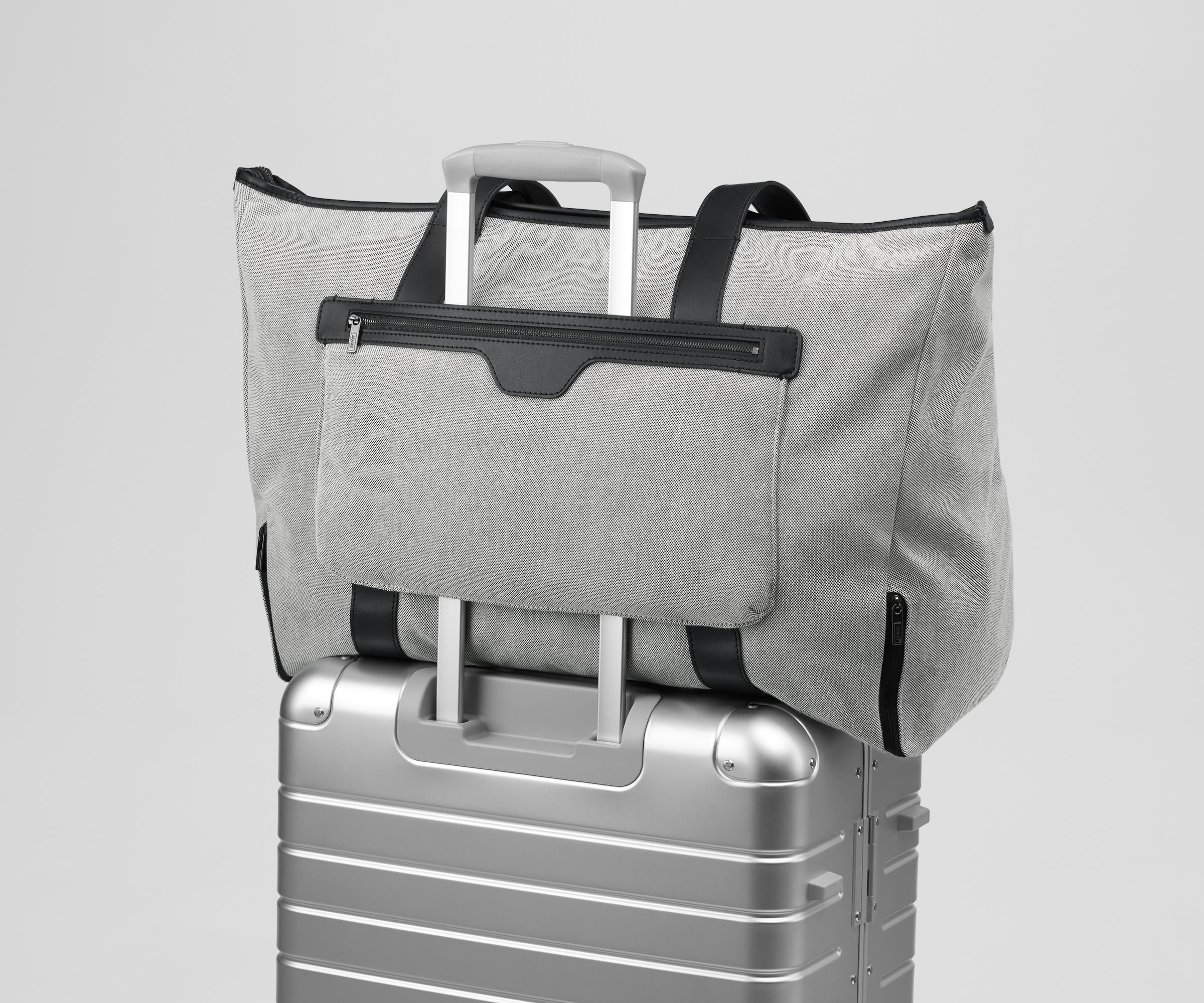 Transit Canvas Tote on top of an Away aluminum suitcase