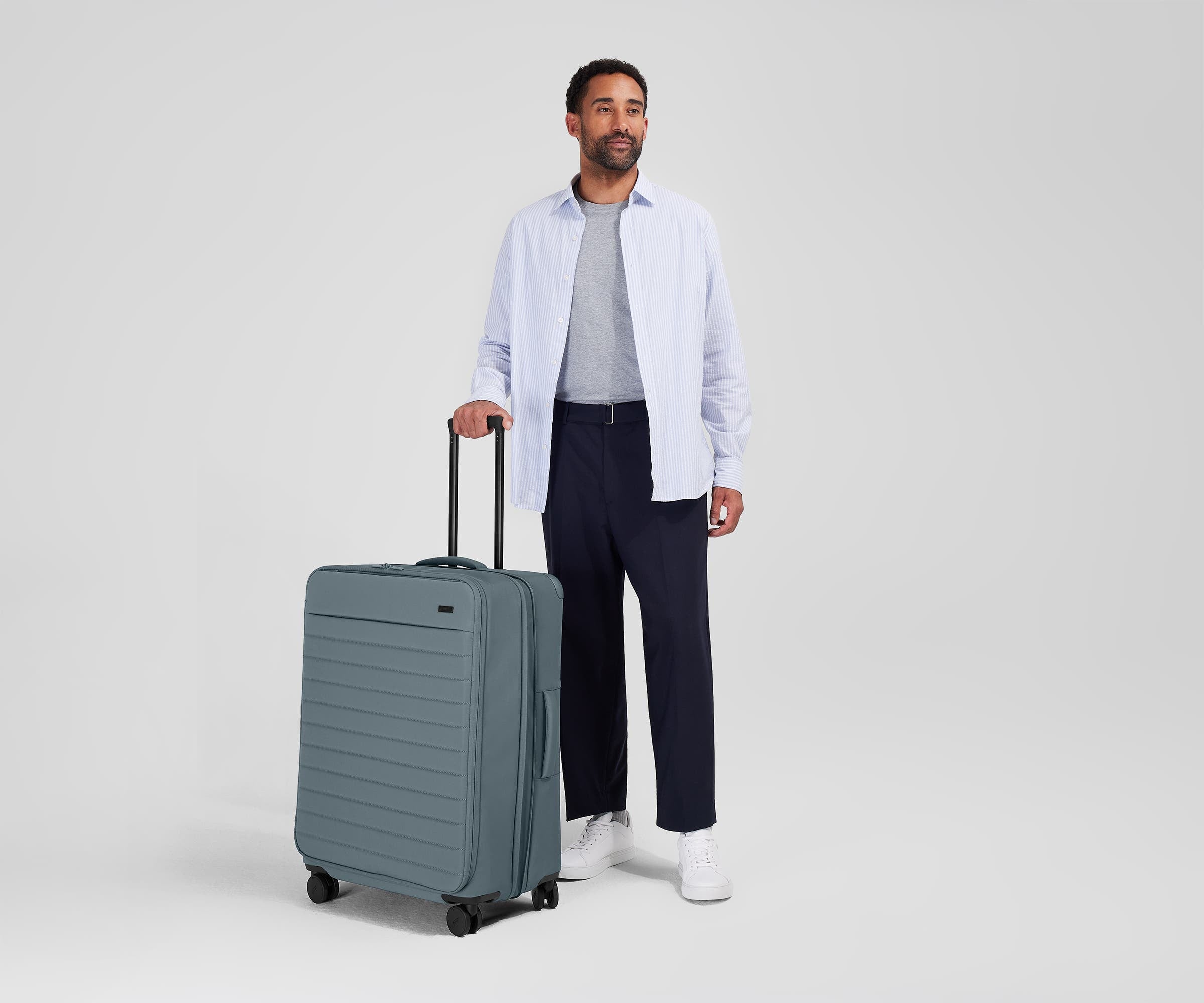 Person standing next to the Softside Large for scale