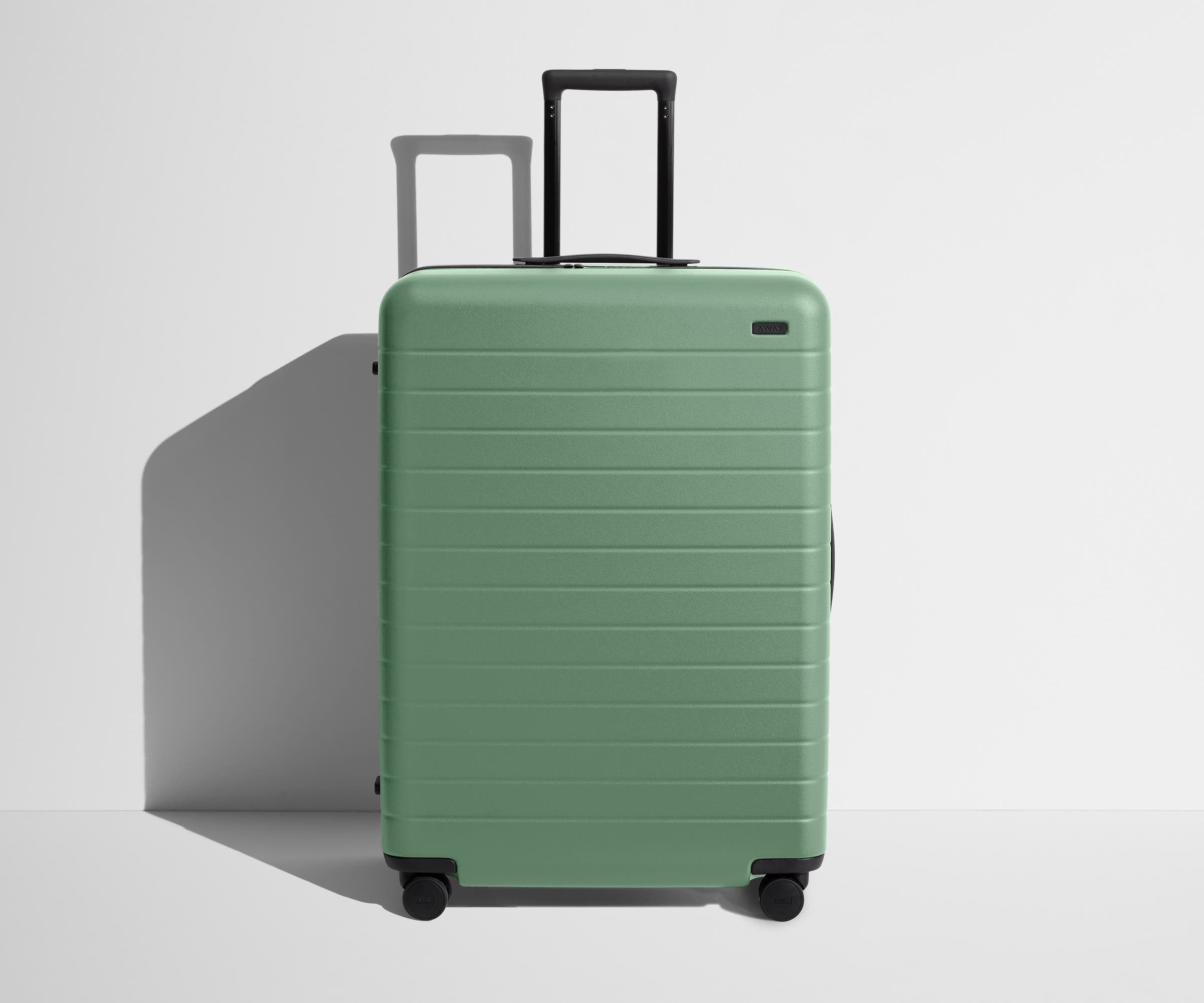 Front product view of The Large suitcase in Sea Green with raised handle