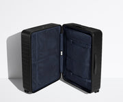 The Large suitcase in Jet Black shown open in an upright position to show interior organization and compression system