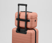 Train Case on top of an Away suitcase
