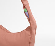 Chapstick in the discreet, zippered strap pocket