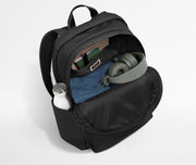 Front compartment packed with a notebooks, headphones, and clothing