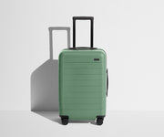 Front product view of The Carry-On suitcase in Sea Green with raised handle