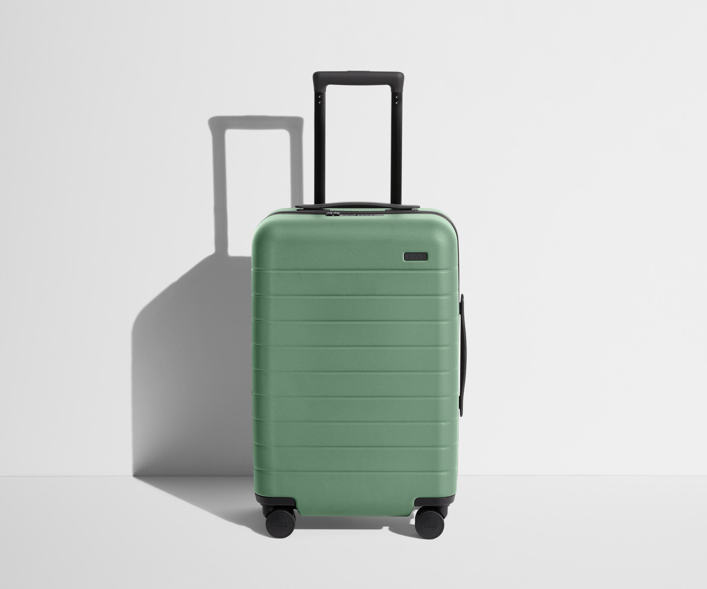 Front product view of The Carry-On suitcase in Sea Green with raised handle