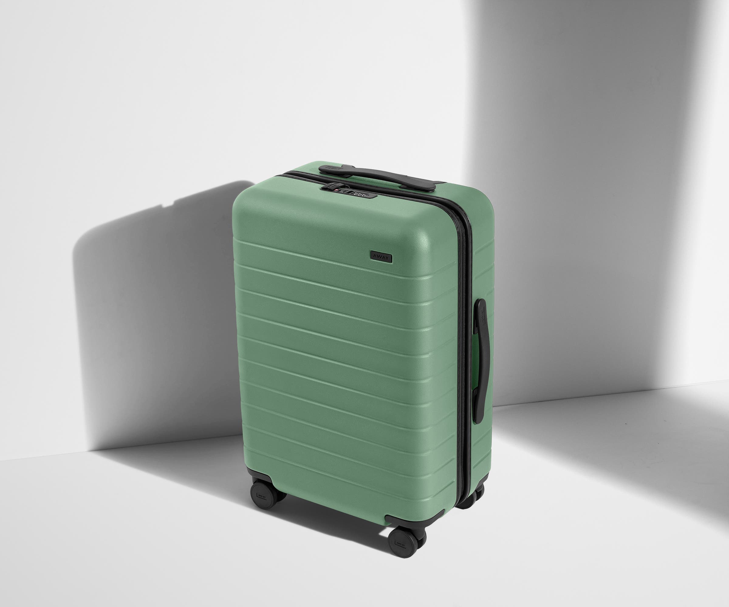 Angled product view of The Bigger Carry-On suitcase in Sea Green