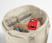 Interior packed with clothing, a laptop, headphones, notebook, and camera