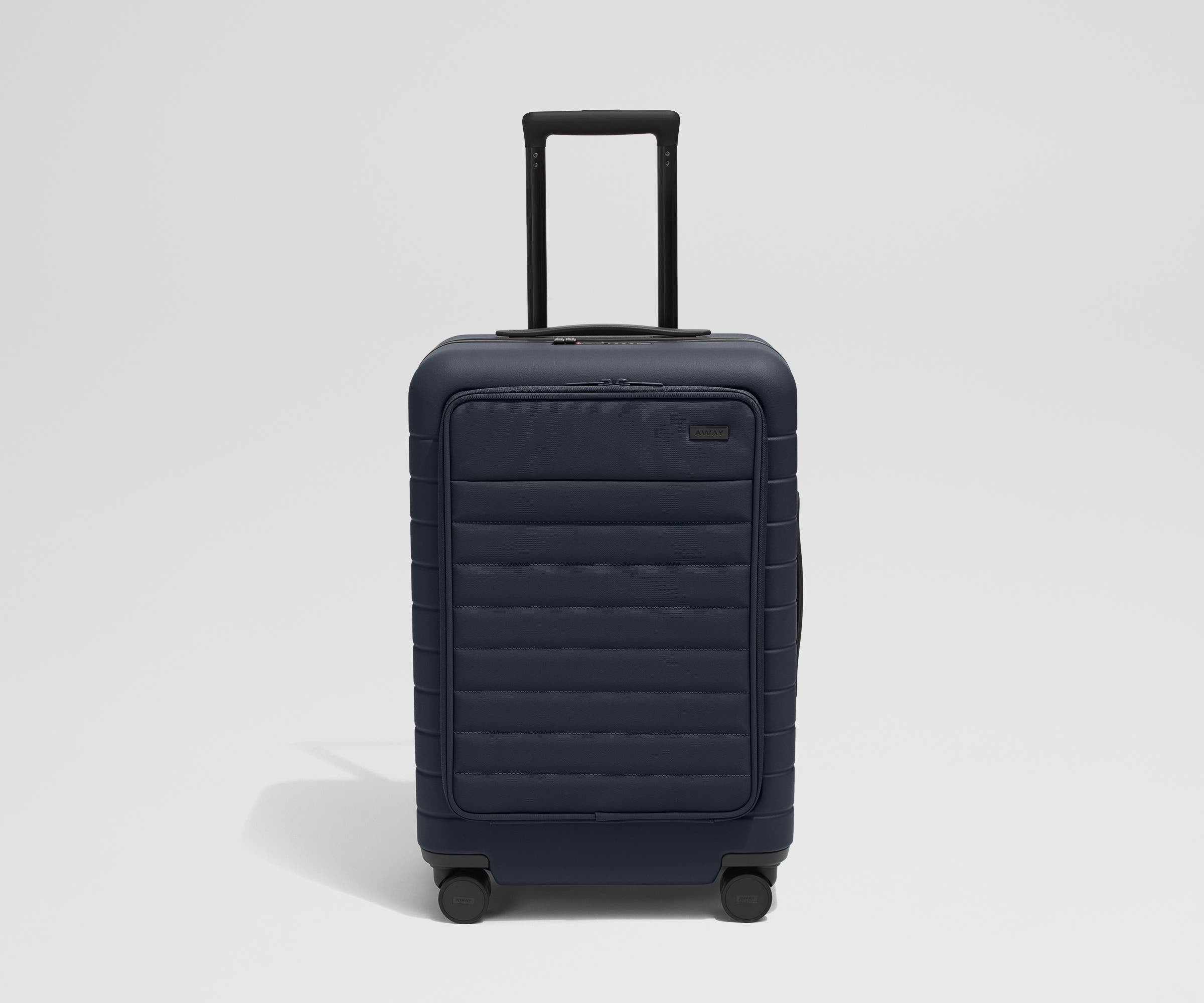 Front product view of The Front Pocket Bigger Carry-On suitcase in Navy Blue with raised handle