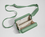 Unzipped, open view of The Mini Crossbody, showing the two main compartments and slip pocket