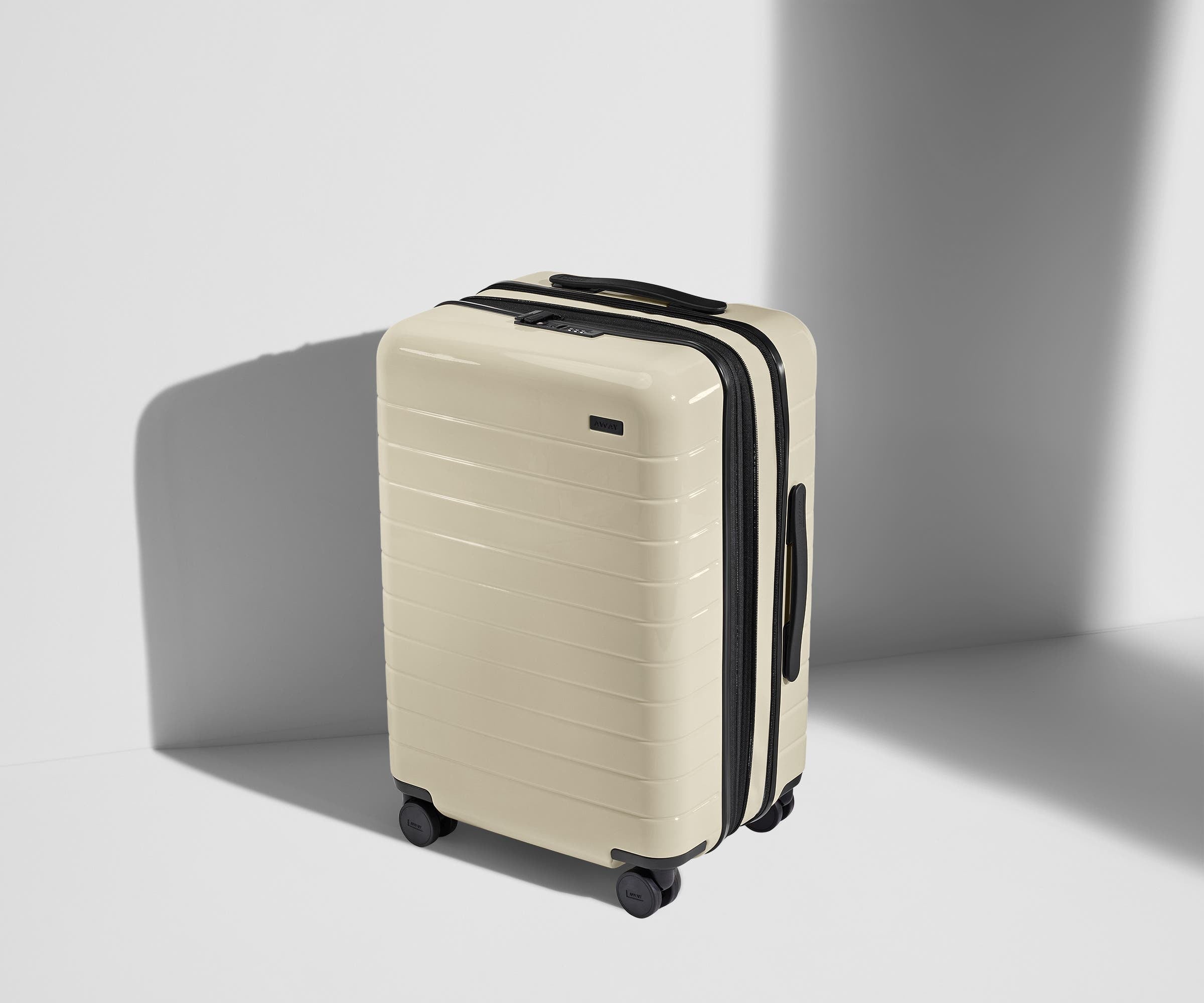 Angled product view of The Bigger Carry-On Flex suitcase in Salt White (Gloss)