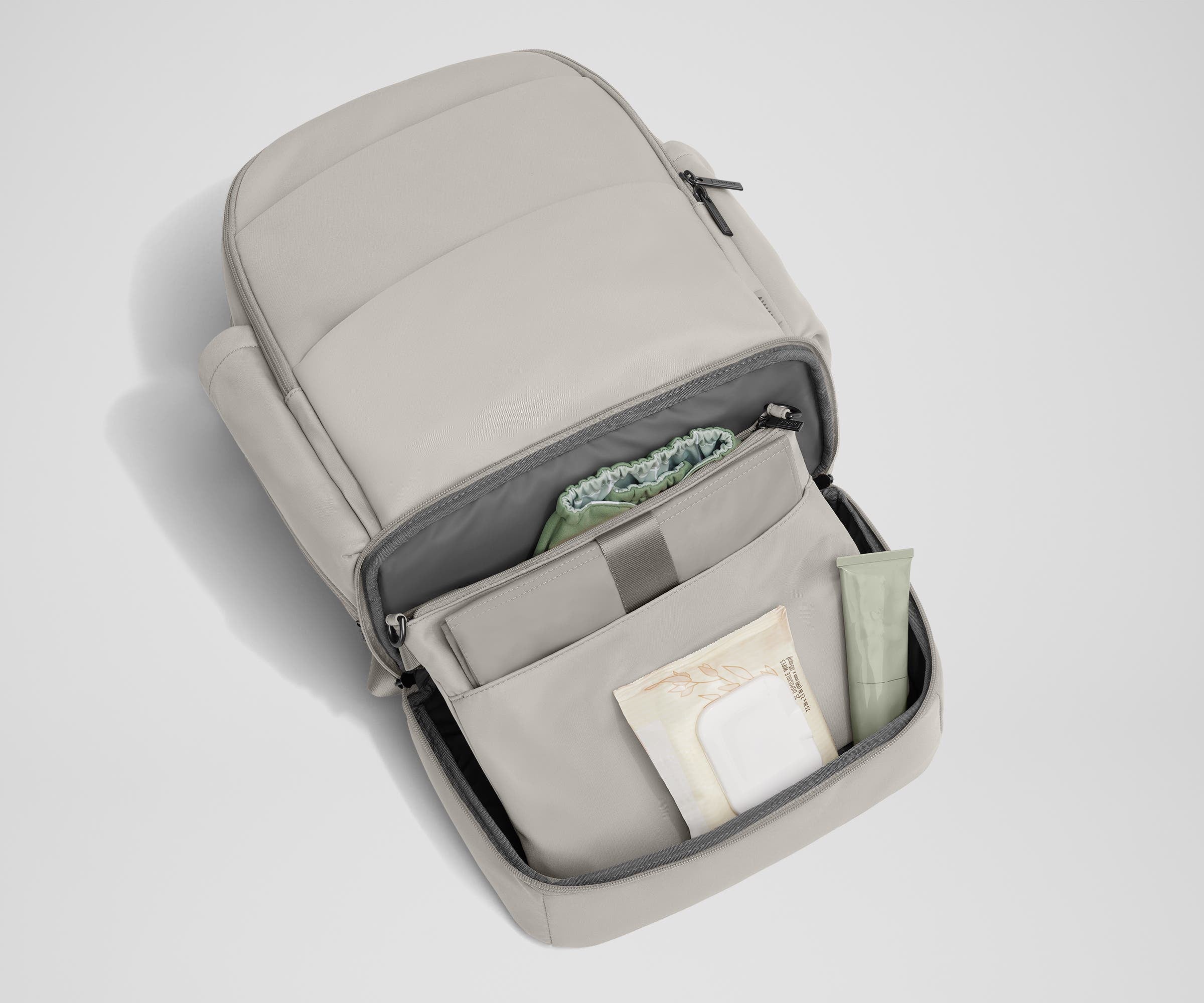 Bottom compartment shown with the included changing pad and Carry-All pouch that fits diapers and wipes