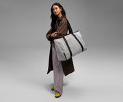 Person wearing the canvas tote on their shoulder