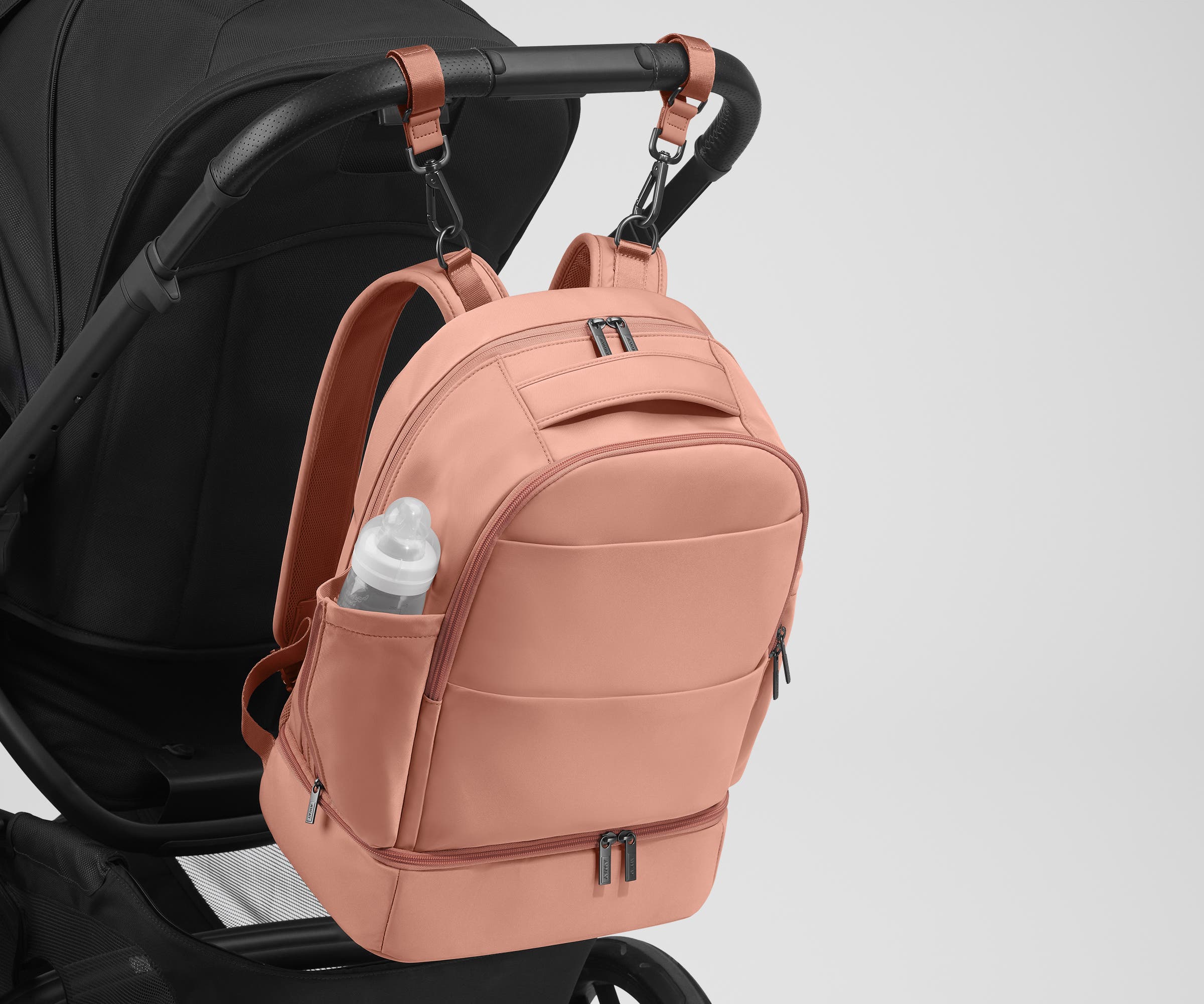 Backpack attached to a stroller using the included stroller clips