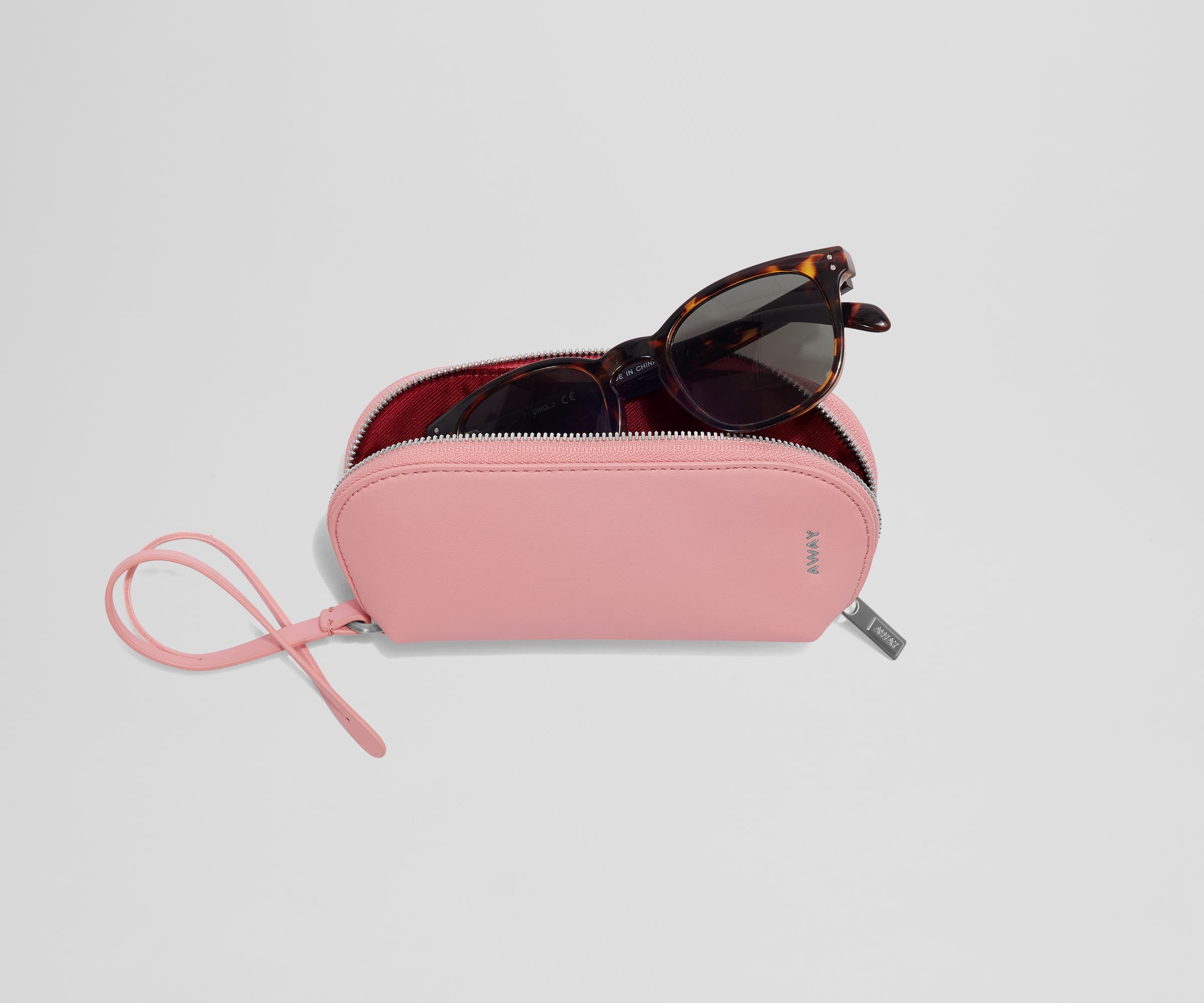 A pair of sunglasses inside an open Sunglasses Pouch