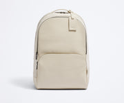 Front view of the Transit Leather Backpack and the dyed-to-match luggage tag