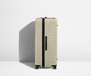 Side product view of The Trunk suitcase in Salt White (Gloss) to show the slimmer top lid and deeper main compartment for easy access and packing