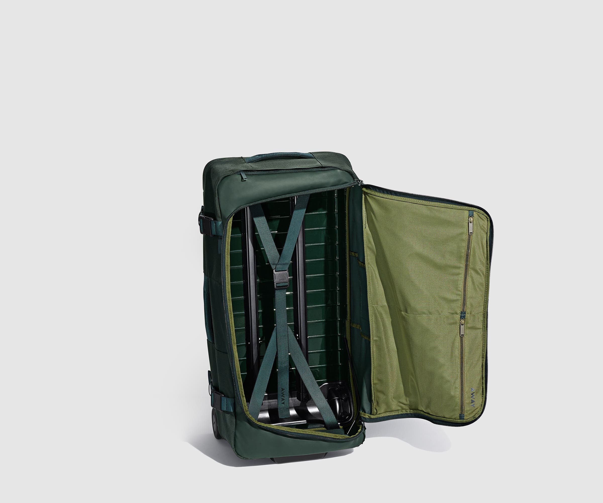 85L Duffle standing upright and unzipped, showing the compression straps and interior pockets