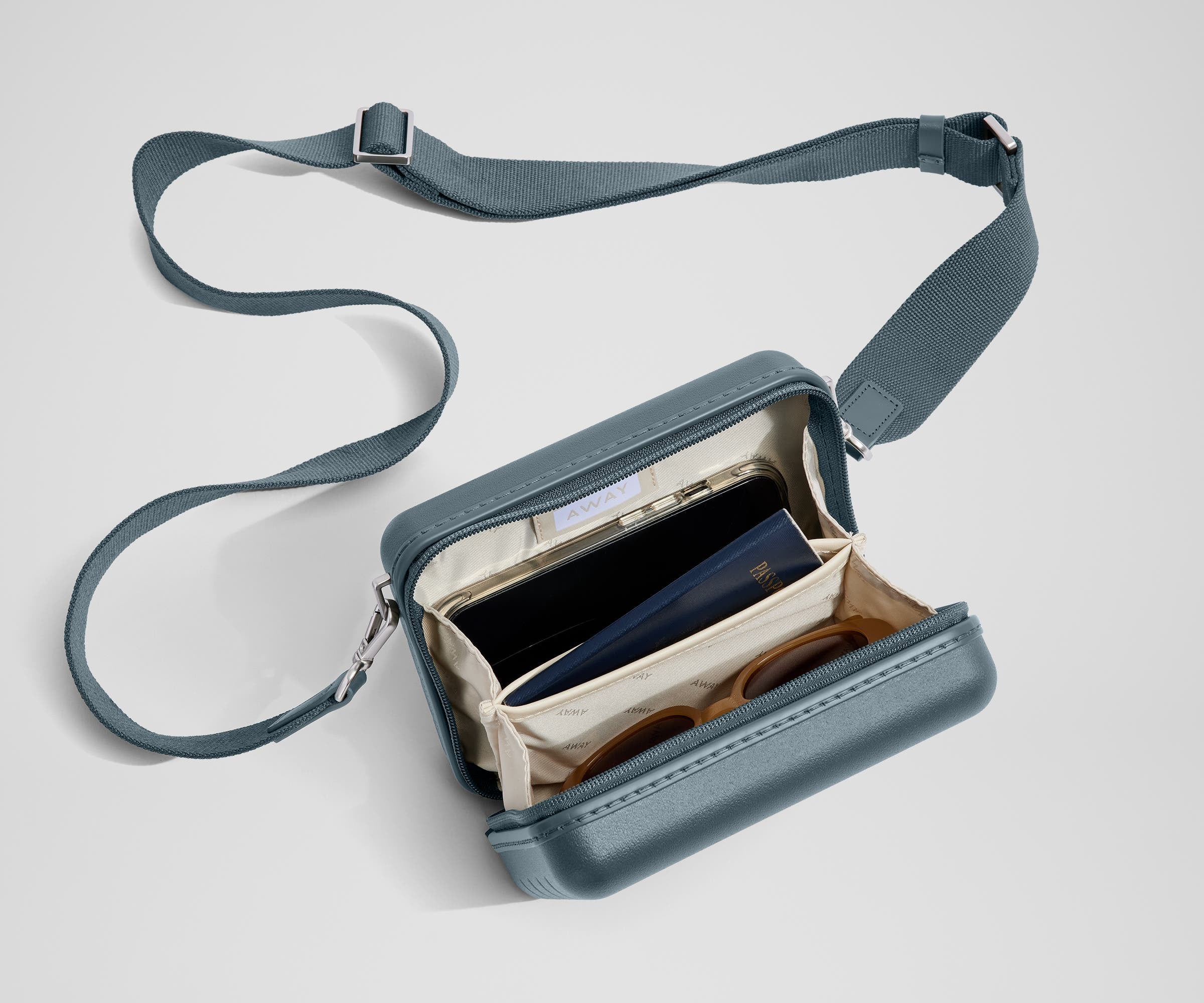The Mini Crossbody packed with a phone, passport, and sunglasses