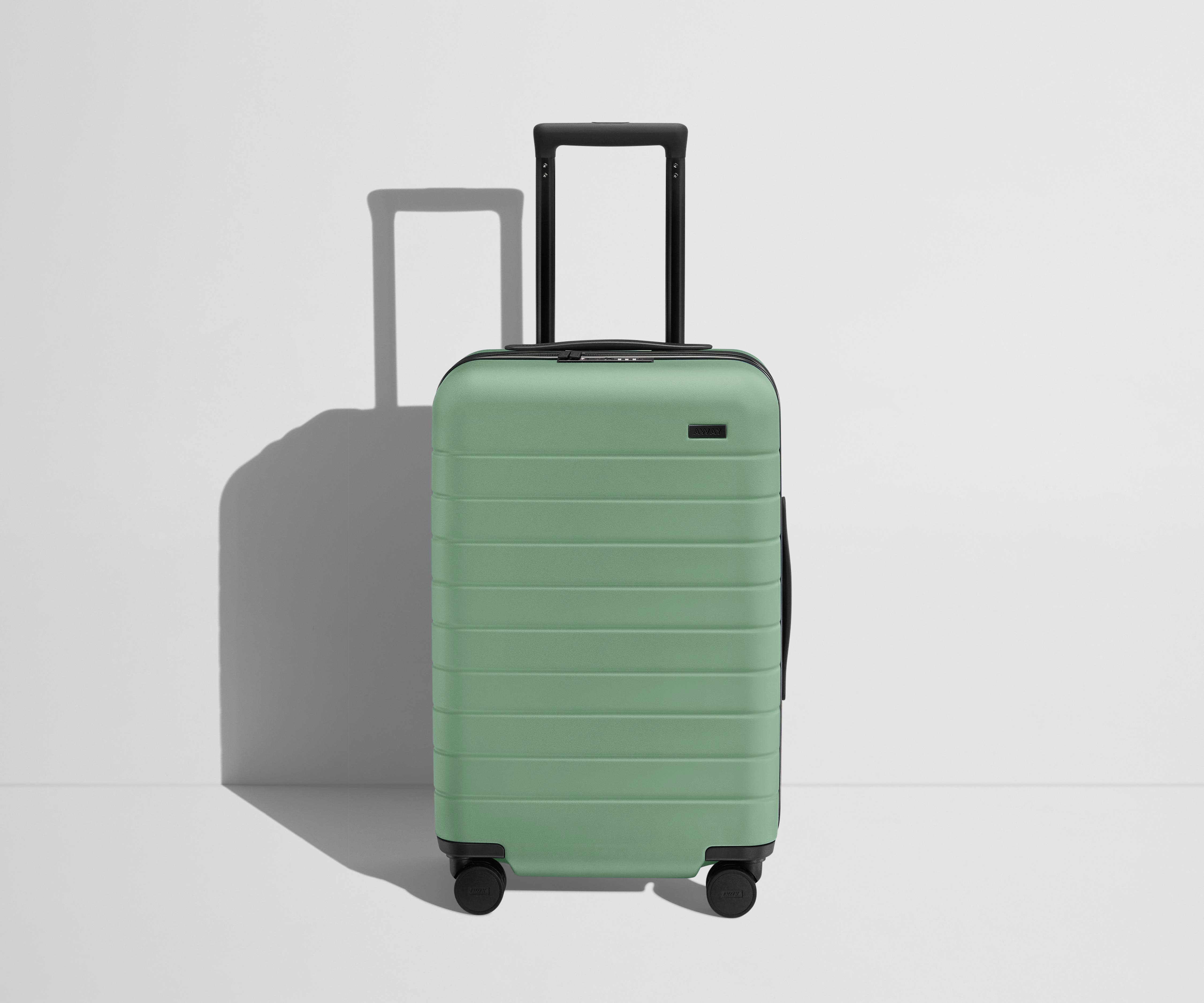 Front product view of The Carry-On Flex suitcase in Sea Green with raised handle